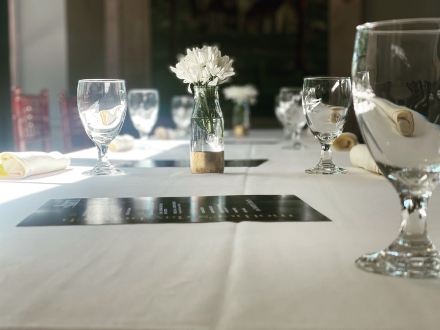 White-linen table set with flowers and glassware