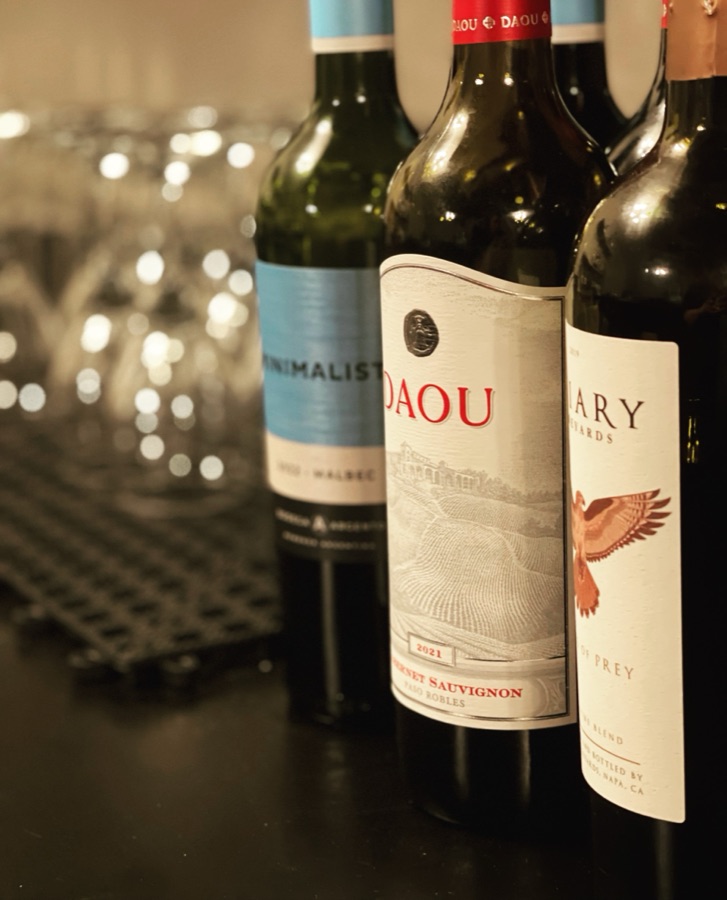 Bottles of red wine on a bar