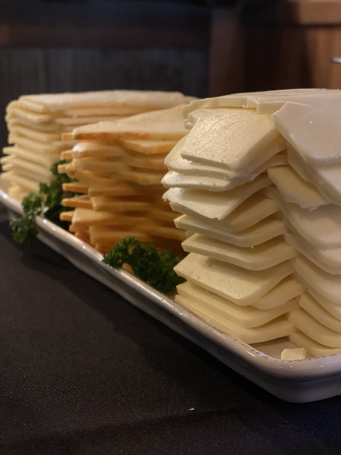 Platter of neatly sliced cheese