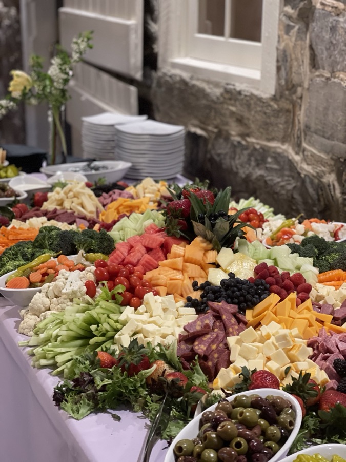 Grazing table filled with fruit, cheese, and vegetables