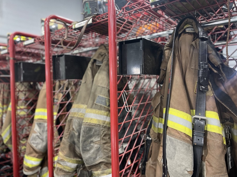 Firefighter turnout gear hanging on a rack