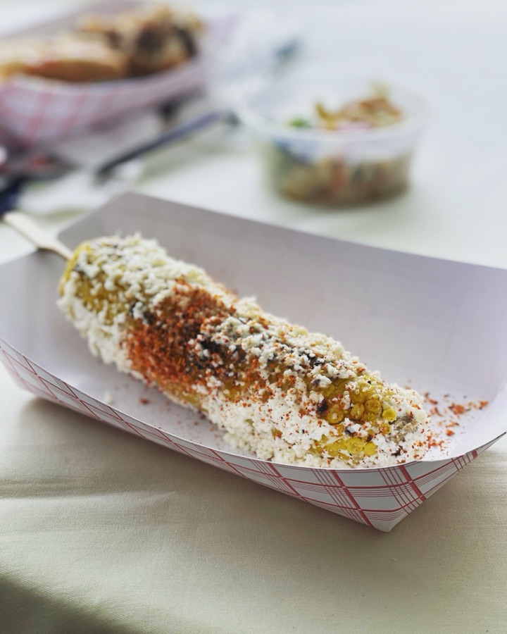 Mexican street corn in a paper tray