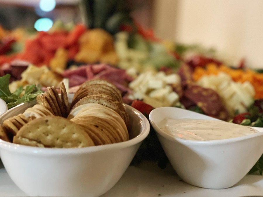 Charcuterie board with crackers and dip