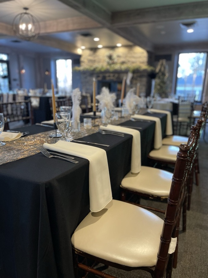 Event dining room with long, elegantly set tables