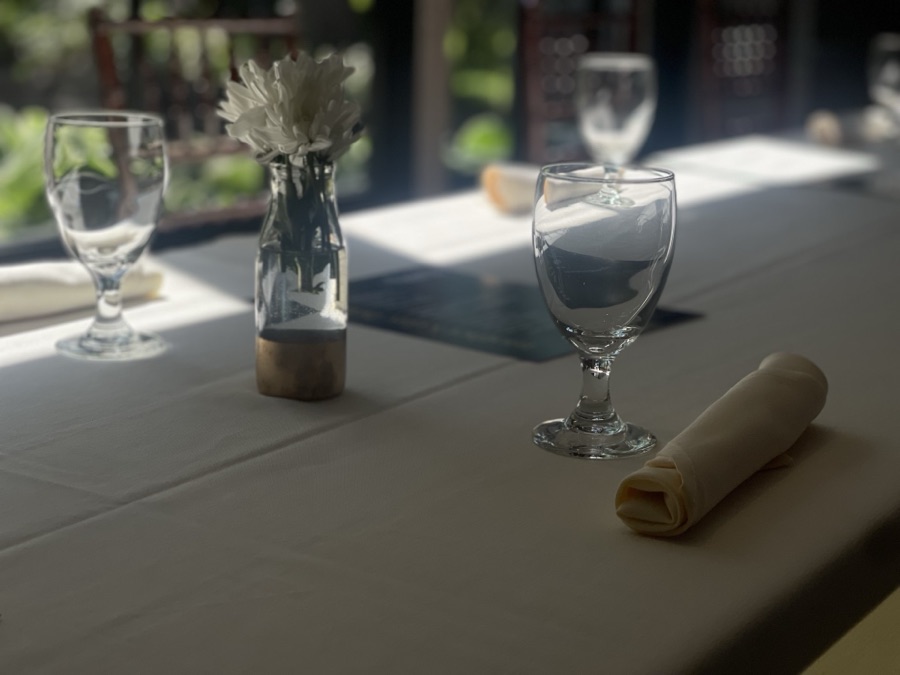 Table with a flower vase and a wine glass