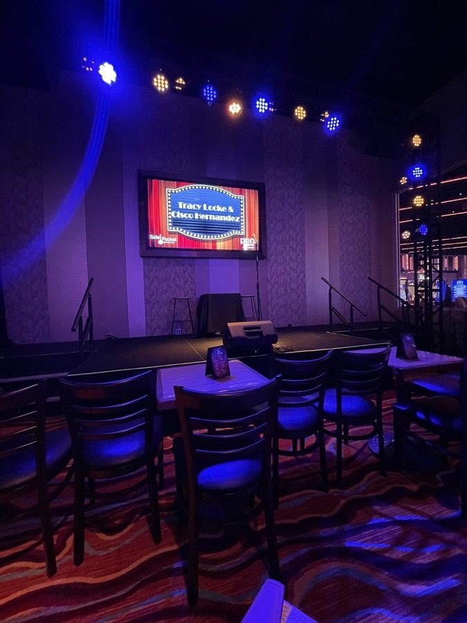 Comedy club stage lit in blue before a show