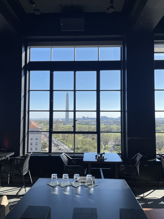 Restaurant view of the Washington Monument through tall windows