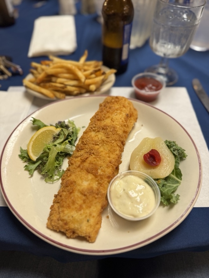 Fried fish platter with fries, salad, and tartar sauce