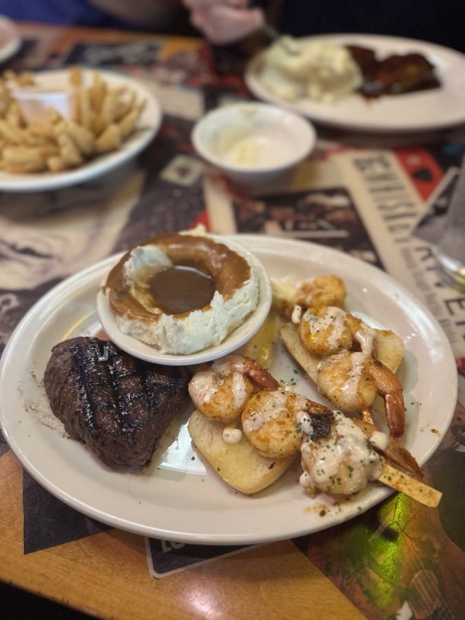 Steak and shrimp dinner with mashed potatoes