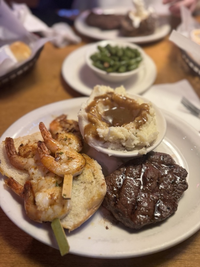 Steak and grilled shrimp with mashed potatoes and green beans