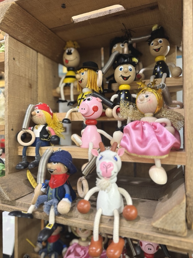Handmade wooden figurines on display shelves