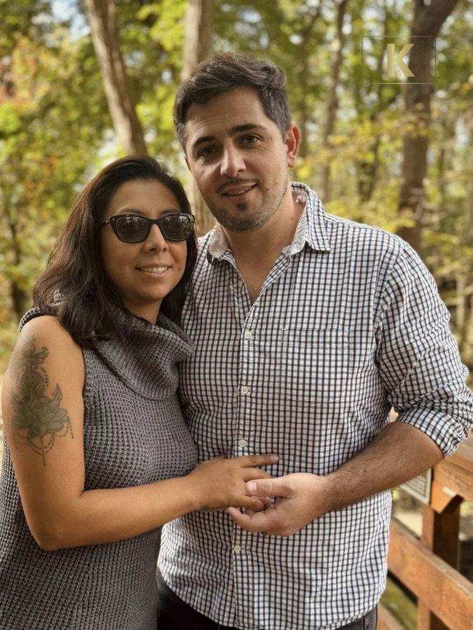 Couple posing together among the trees