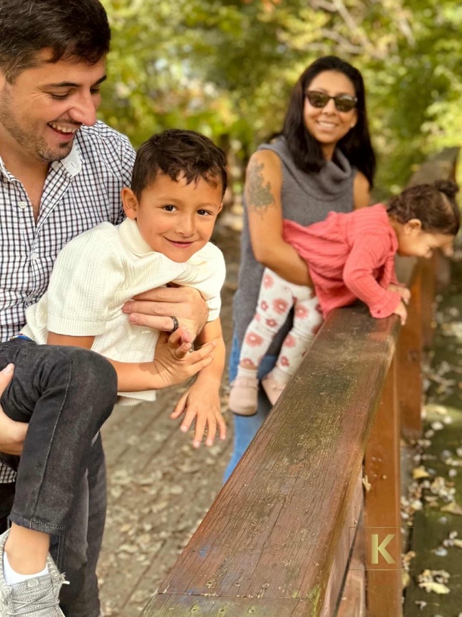 Family playing together on a wooden bridge