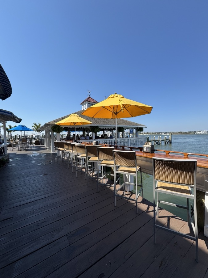 Waterfront deck bar with yellow umbrellas