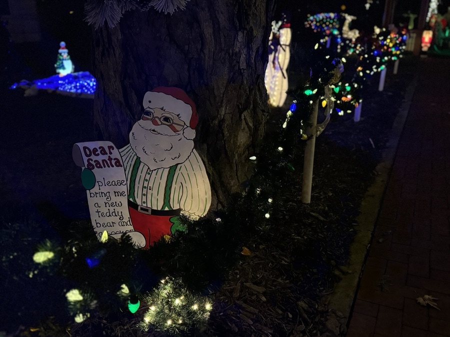 Hand-painted Santa cutout among holiday lights